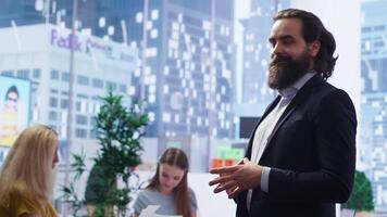 Portrait of smiling financial advisor sitting in office with parent and child to provide personalized spending planning. Upbeat agent in workspace evaluating clients financial needs, camera B video
