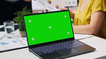 Financial adviser doing presentation on isolated screen laptop to help clients build saving habits, close up. Agent using chroma key notebook to show customers investing tips, camera A video