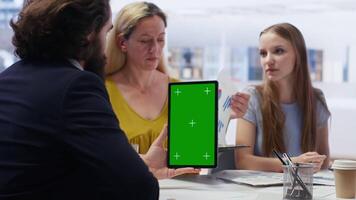 People receiving personalized financial plan from financial advisor using isolated screen tablet. Customers learn how to make profitable decisions from agent using chroma key device, camera B video