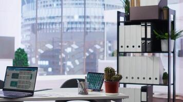 Empty company financial department with stock portfolio on device containing collection of investment assets. Workplace with live index indices on notebook screen showing stock demand surge video