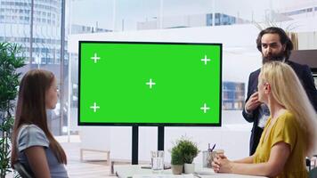 Financial adviser conducting audit of clients income, doing presentation on green screen to help them build saving habits. Agent using large mockup display to show investing tips, camera B video