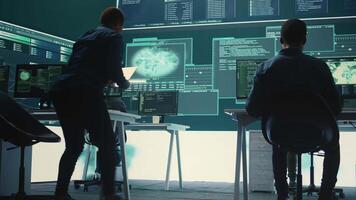 Governmental hacking group targeting sensitive information through high tech cyber attacks, digital espionage. Team of IT experts working on national security and data privacy servers. Camera B. video