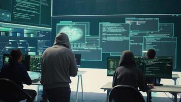 Group of governmental hackers successfully breaking into servers to steal important data, experts feeling happy and proud of their criminal achievement. Espionage system in high tech agency. Camera B. video