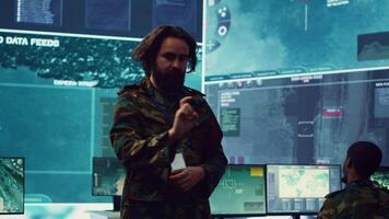 Command sergeant major employs high tech holograms to examine real time data for a mission, working on ways to protect the national coast line. Creating an attack plan. Camera A. video