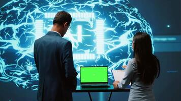 AI developers using isolated screen device for business data analysis. IT department staff members work on chroma key notebook to automatize tasks using artificial intelligence, camera A video