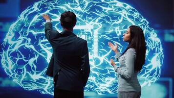 Engineer wearing VR headset and coworker working with artificial intelligence neural networks. Colleagues using virtual reality technology and AI system in high tech workspace, camera B video