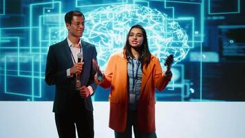 Presenter and specialist guest talking at AI summit bringing together tech startups professionals, exploring latest developments in artificial intelligence and deep learning technology, camera A video