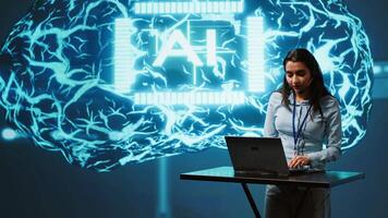 Technician in high tech workspace managing call center tasks, speaking into headset while doing monitoring with laptop. AI company employee talking with clients through headphones mic, camera A video