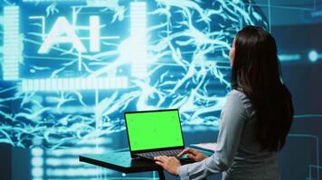 IT specialist using green screen laptop and AI technology for business data analysis in high tech setting. Engineer works on mockup notebook to automatize tasks using artificial intelligence, camera A video