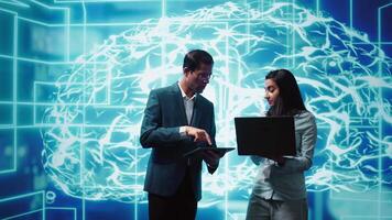 Coworkers using AI neural networks modeled after human brain, brainstorming ways to solve complex problems. IT department staff members using deep learning to look at data and complete tasks, camera B video