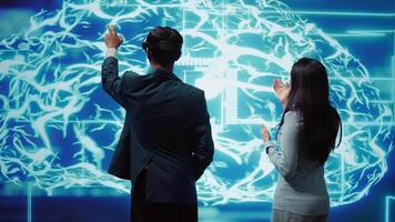 Engineers use VR headset and AR hologram, looking at AI neural networks modeled after human brain. Admins using artificial intelligence, virtual and augmented reality tech to look at data, camera B video