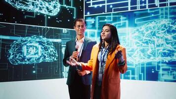 Presenter and specialist guest talking at AI summit bringing together tech startups professionals, exploring latest developments in artificial intelligence and deep learning technology, camera B video