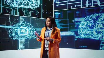 Speaker talking with audience on stage at AI conference bringing together leading experts and researchers to explore latest developments in artificial intelligence and machine learning, camera B video