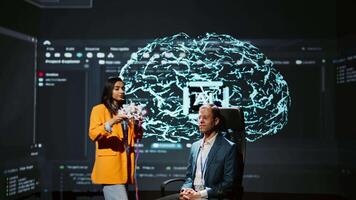 Company CEO using summit as platform to launch latest AI EEG headset product. Neuroscientist doing demonstration at forum in front of business leaders interested in artificial intelligence, camera B video