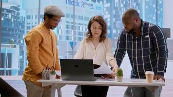 Business professionals and a real estate agent engage in a planning session, discussing the layout and design of a new office space based on detailed blueprints. Property investment. Camera A. video