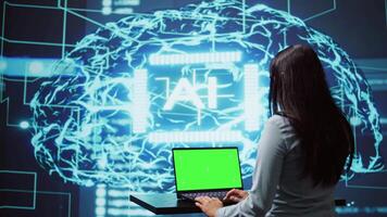 IT specialist using green screen laptop and AI technology for business data analysis in high tech setting. Engineer works on mockup notebook to automatize tasks using artificial intelligence, camera B video