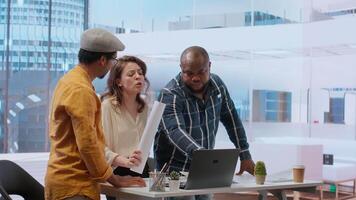 Realtor meeting with entrepreneurs to establish leasing contract terms after evaluating architectural blueprints with clients at desk. Business people negotiating for investment strategy. Camera B. video