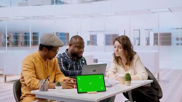 Clients negotiating with realtor next to isolated copy space on tablet, examining layout and blueprints for new high class office space. Business people investing in property with financier. Camera A. video