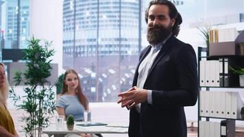 Portrait of smiling financial advisor sitting in office with parent and child to provide personalized spending planning. Upbeat agent in workspace evaluating clients financial needs, camera A video