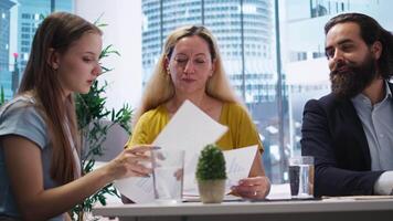 förälder och barn ser över personlig planera guide skriven förbi finansiell rådgivare under möte. konsult optimerande utgifterna vanor av klienter begärande hjälp, kamera en video