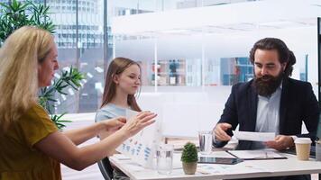 Financial adviser providing clients with informative leaflets on retirement planning, tax issues and wealth management. Agent in office assisting clients in setting up investment accounts, camera A video