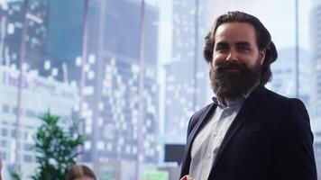 Portrait of happy financial advisor meeting with clients to recommend financial products and investments such as stocks and bonds. Cheerful agent informs family of best investment strategies, camera B video