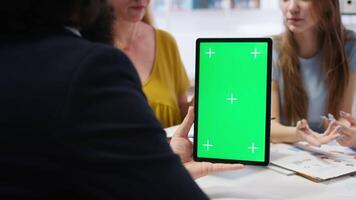 Financial adviser assisting clients in setting up investment accounts with green screen tablet, conducting audit. Consultant uses financial planning software on mockup device to help family, camera A video