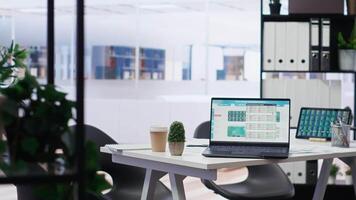 Empty office with stock exchange portfolio on devices containing collection of investment bonds and other financial assets. Real time index indices showing stock demand surge on laptop and tablet video