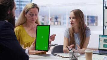Financial adviser assisting clients in setting up investment accounts with green screen tablet, conducting audit. Consultant uses financial planning software on mockup device to help family, camera B video