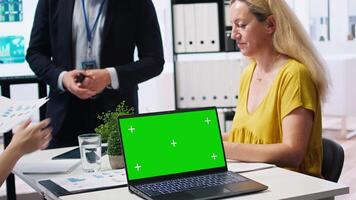 Financial adviser presents market analytics on isolated screen laptop to clients, teaching them how to build portfolio. Broker showing stock exchange charts on chroma key notebook to family, camera A video