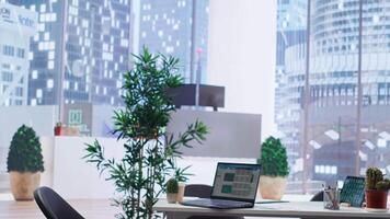 Laptop on desk in office showing stock exchange indices changing in real time. Notebook in workplace with forex trading indexes displayed live showing latest price modifications video