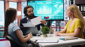 Financial adviser conducting audit of clients income, developing predictive financial models. Agent crafts customized economic strategies based on customers goals and risk tolerance, camera A video