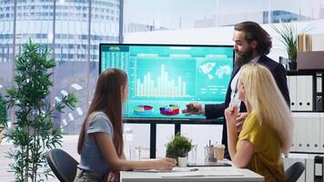 Financial adviser presents market analytics to customers using large display, emphasizing data driven decision making. Broker agent showing statistical graphs about stock exchange shares, camera B video