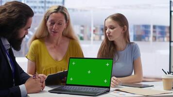 Clients looking over personalized planning guide on green screen laptop written by financial advisor during meeting. Consultant optimizing living expenses for customers using mockup notebook, camera B video