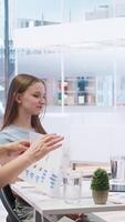Vertical Financial adviser providing clients with informative leaflets on retirement planning, tax issues and wealth management. Agent in office assisting clients in setting up investment accounts, camera A video