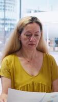 Vertical Financial advisor talking with clients, recommending optimal financial services and investments. Agent informing mother and young adult of best investment strategies, camera A video