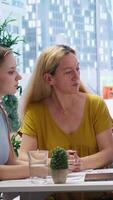 Vertical Financial advisors meeting with clients to counsel them on their finances and give them personalized financial plan. Agent guiding family in making profitable and secure decisions, camera A video