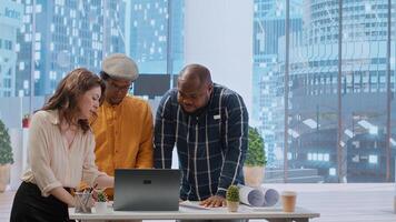 Business professionals and a real estate agent engage in a planning session, discussing the layout and design of a new office space based on detailed blueprints. Property investment. Camera B. photo