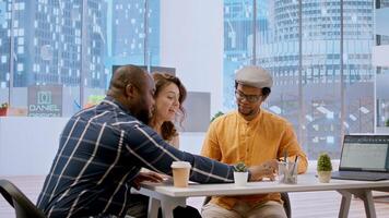 Brokers team and entrepreneur discussing a real estate potential, evaluating architectural plans and negotiating contract terms for renting a high class office space. Rental agreement at desk. Camera A. photo