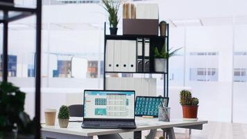 Stock market shares going up and down on laptop in empty financial department office, price volatility concept. Forex trading economic analytics figures on notebook screen in workplace photo