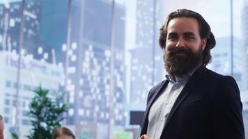 Portrait of happy financial advisor meeting with clients to recommend financial products and investments such as stocks and bonds. Cheerful agent informs family of best investment strategies, camera B photo