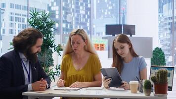 Family members receiving personalized financial plan from financial advisor during meeting. Customers learn how to make profitable decisions from agent using notebook, camera B photo