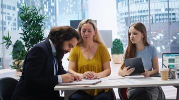 Clients completing forms, taking loan from financial agent, doing handshake after completing deal. Mother and daughter signing contract, entering agreement with financial consultant, camera A photo