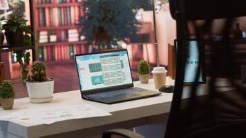Empty home setup belonging to an entrepreneur with data sales analytics and financial reports on laptop, accountancy information and invoices for remote work. Finance and economy. photo
