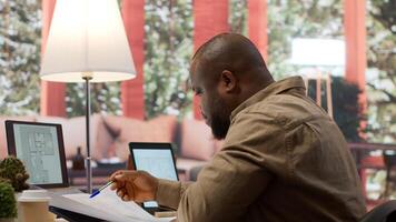 Businessman analyzing architecture blueprints for new office space layout, looking to relocate startup. Entrepreneur conducts an office hunt, business development and strategy planning. Camera A. photo