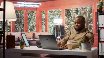 Entrepreneur transmitting financial data reports and discussing resources allocations with shareholders on a videocall from his home desk. Businessman meets with investors online. Camera B. photo