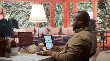 Professional IT engineer at his desk working on AI coding and deep learning projects, showcasing innovation in software development and cloud computing. Internet of things. Camera B. photo