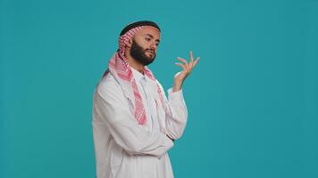 Middle eastern adult acting puzzled and thinking about new ideas, being interested in a subject and trying to obtain answer. Young person being curious on camera, wondering about solution. photo