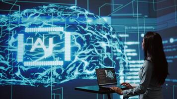 AI computer scientist using laptop for business data analysis in high tech workspace. Close up shot of Indian woman working on notebook to automatize tasks using artificial intelligence, camera B photo