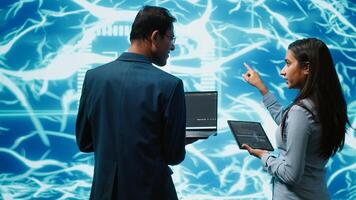 Programmers using devices and AI neural networks modeled after human brain to solve complex problems. Workers using artificial intelligence deep learning to look at data and complete tasks, camera A photo